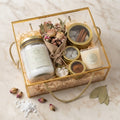 SOLKSH Customised Housewarming Hamper in gold glass box with ritual salts, candle, and dried botanicals